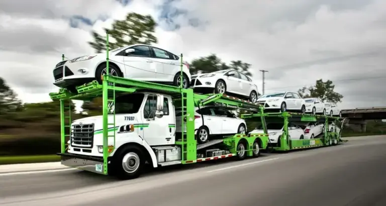 Car carrier truck transporting multiple vehicles on a highway in UAE, representing professional car shipping services to GCC, Saudi Arabia, Qatar, Oman, Bahrain, and international destinations.