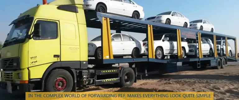 Car carrier truck transporting vehicles from Dubai to Oman along GCC desert route, representing professional UAE to Oman car shipping services by Tawam Al Shahin Transport.